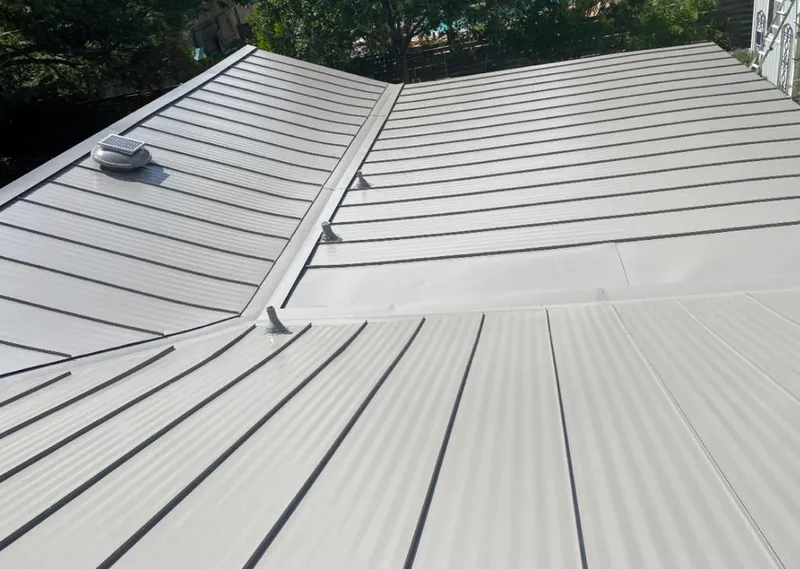 Solar attic fan installed on a metal roof for Roof Ventilation in Rockaway